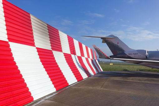Curved Jet Blast Barriers changes the direction of the return of a jet engine
