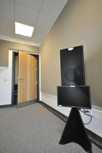 Listening booth with door ajar and speakers